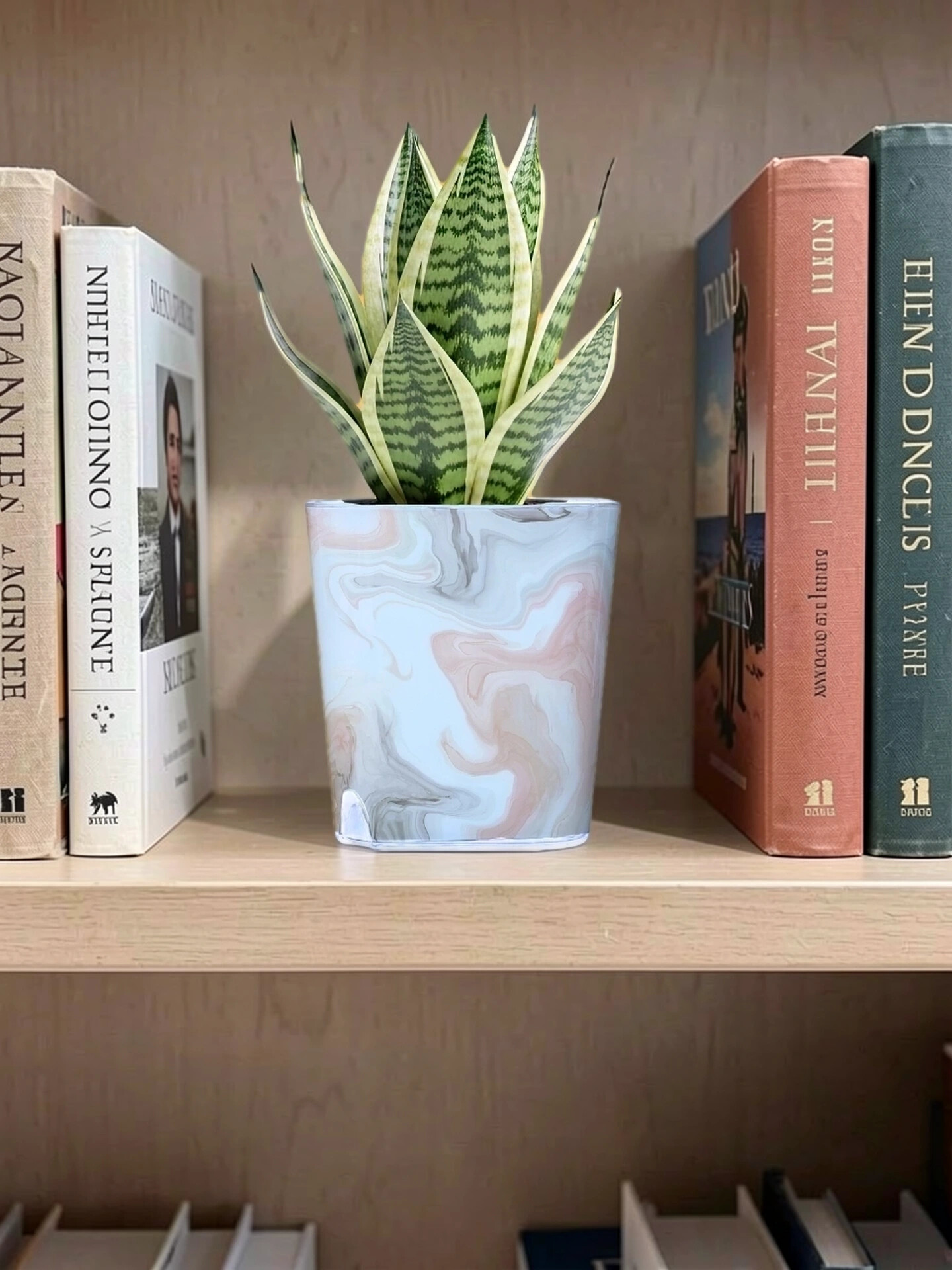 Round and square glossy planters styled together on a shelf